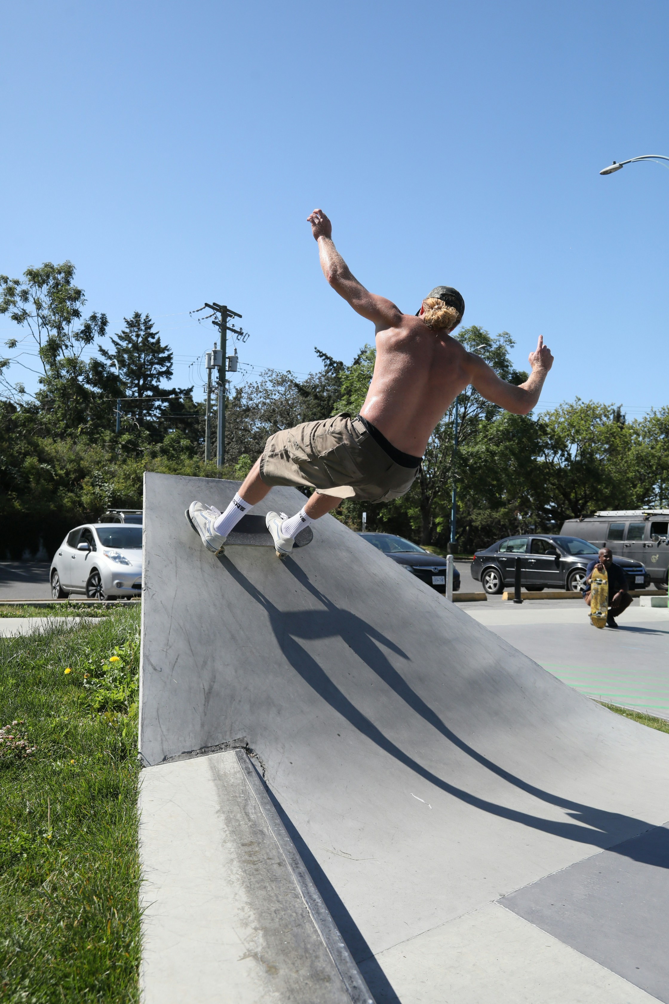 A man riding a skateboard up the side of a ramp