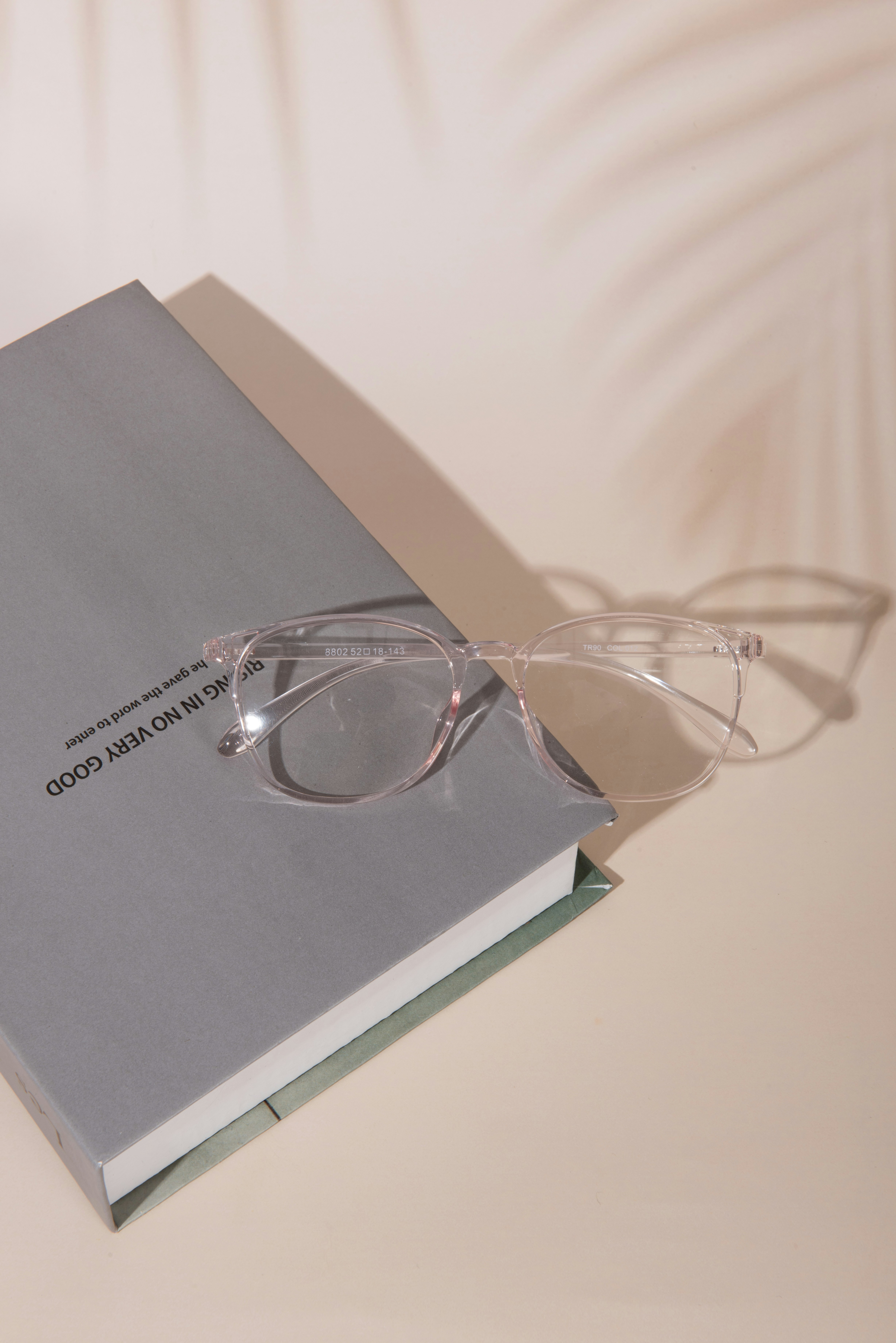 A pair of glasses sitting on top of a book