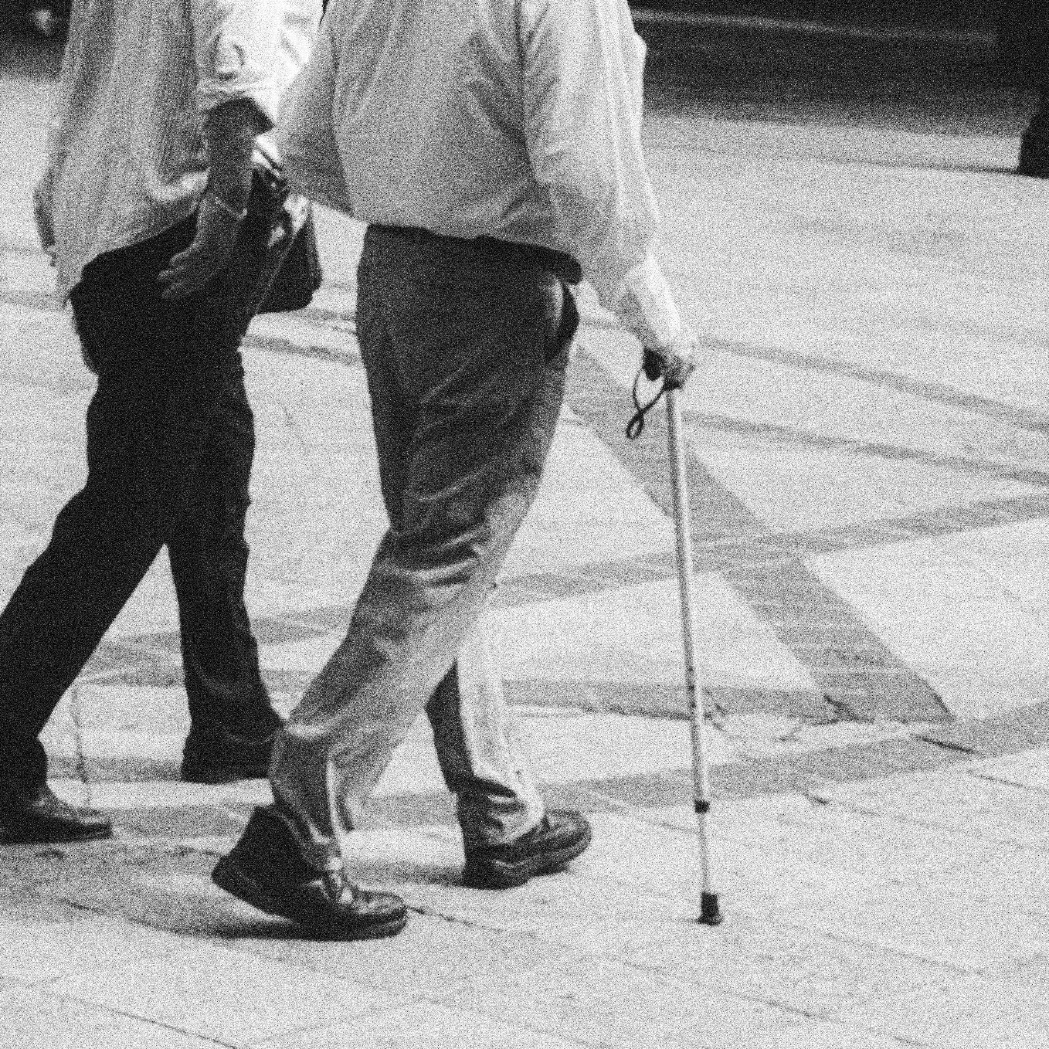 A couple of men walking down a sidewalk