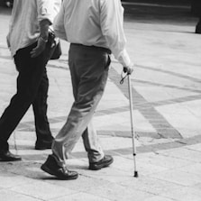 A couple of men walking down a sidewalk