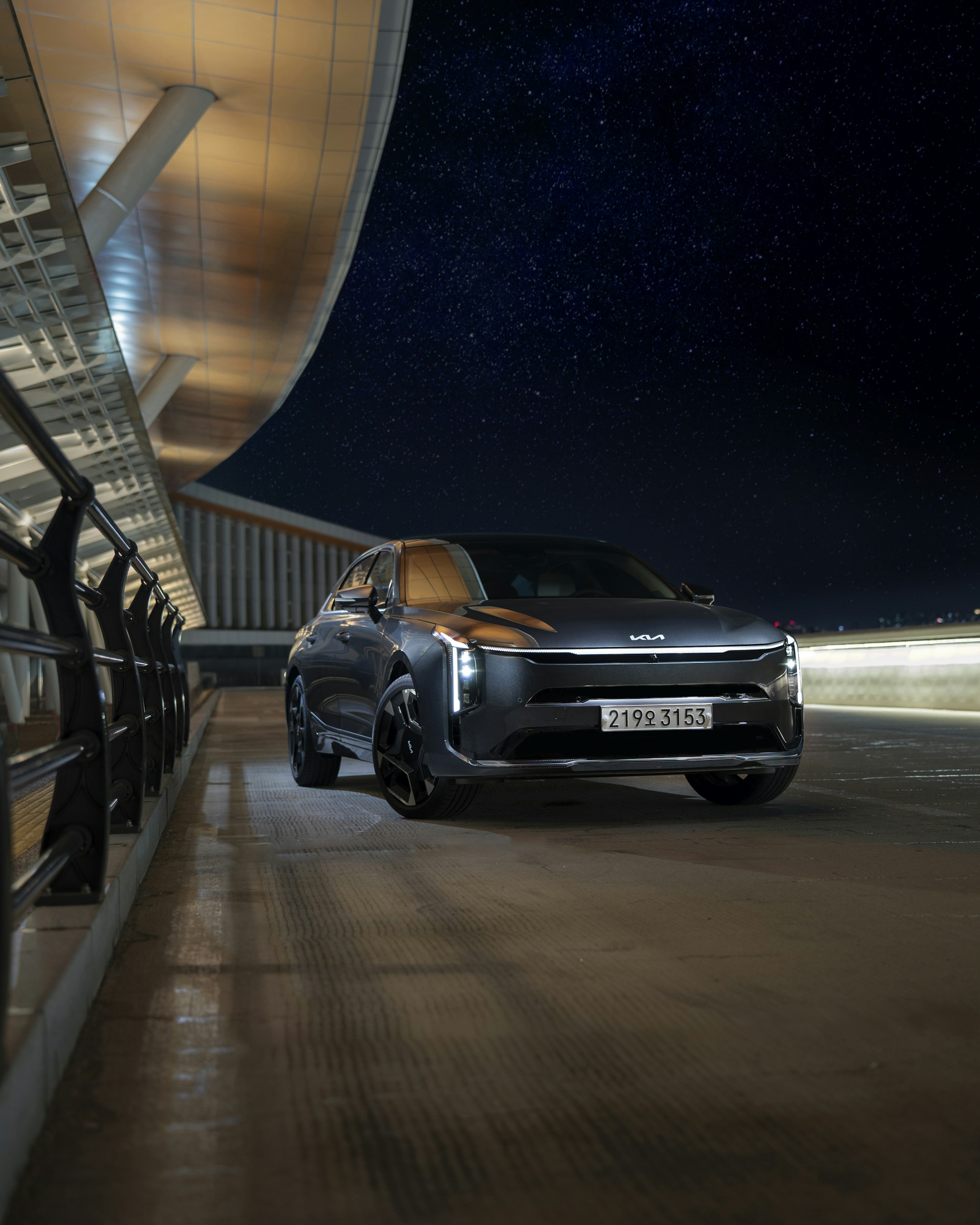 A car parked in front of a building at night
