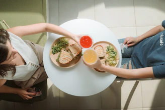 A woman sitting at a table with a plate of food
