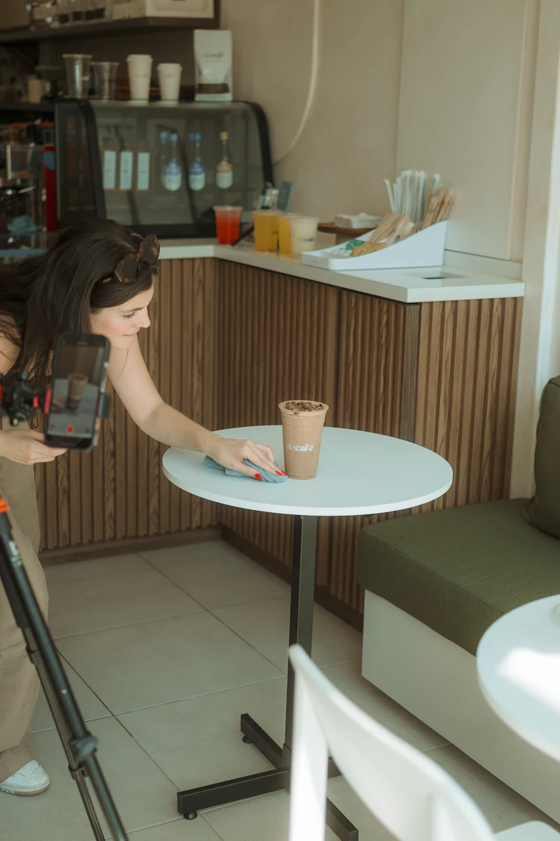 A woman in a bright, minimal café