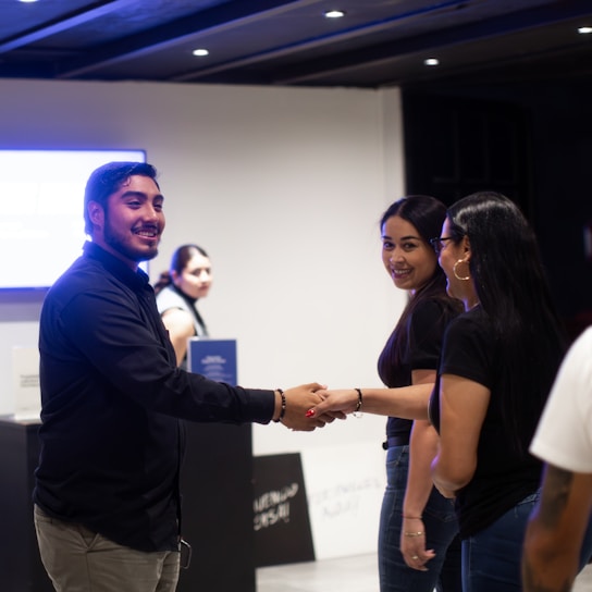 A group of people shaking hands in a room