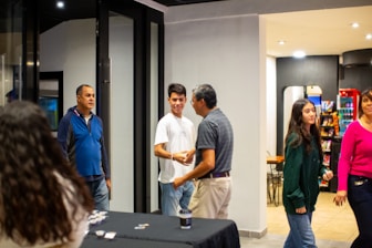 A group of people standing around a table
