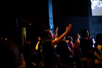 A group of people standing in front of a projector screen