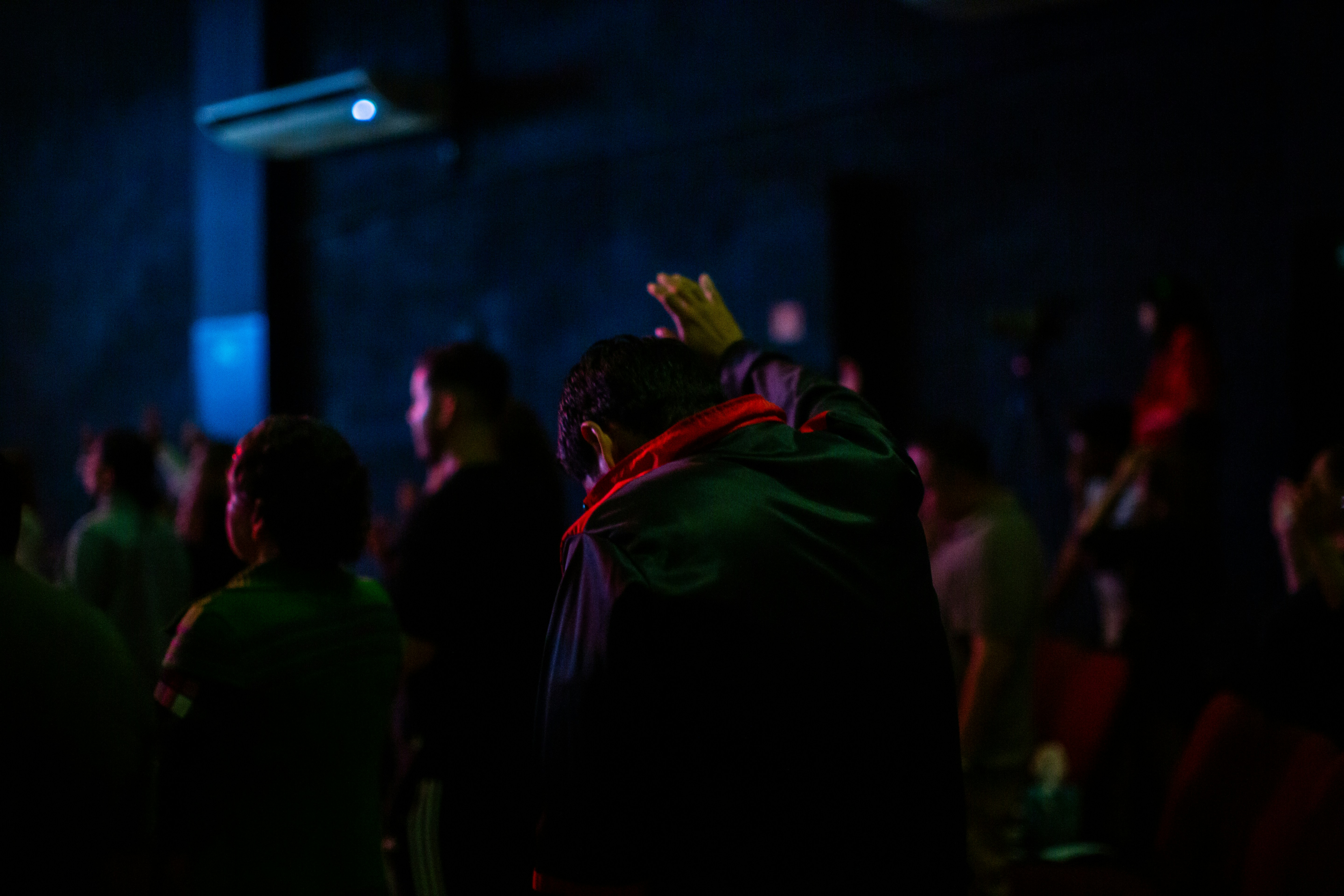 A group of people standing in a dark room