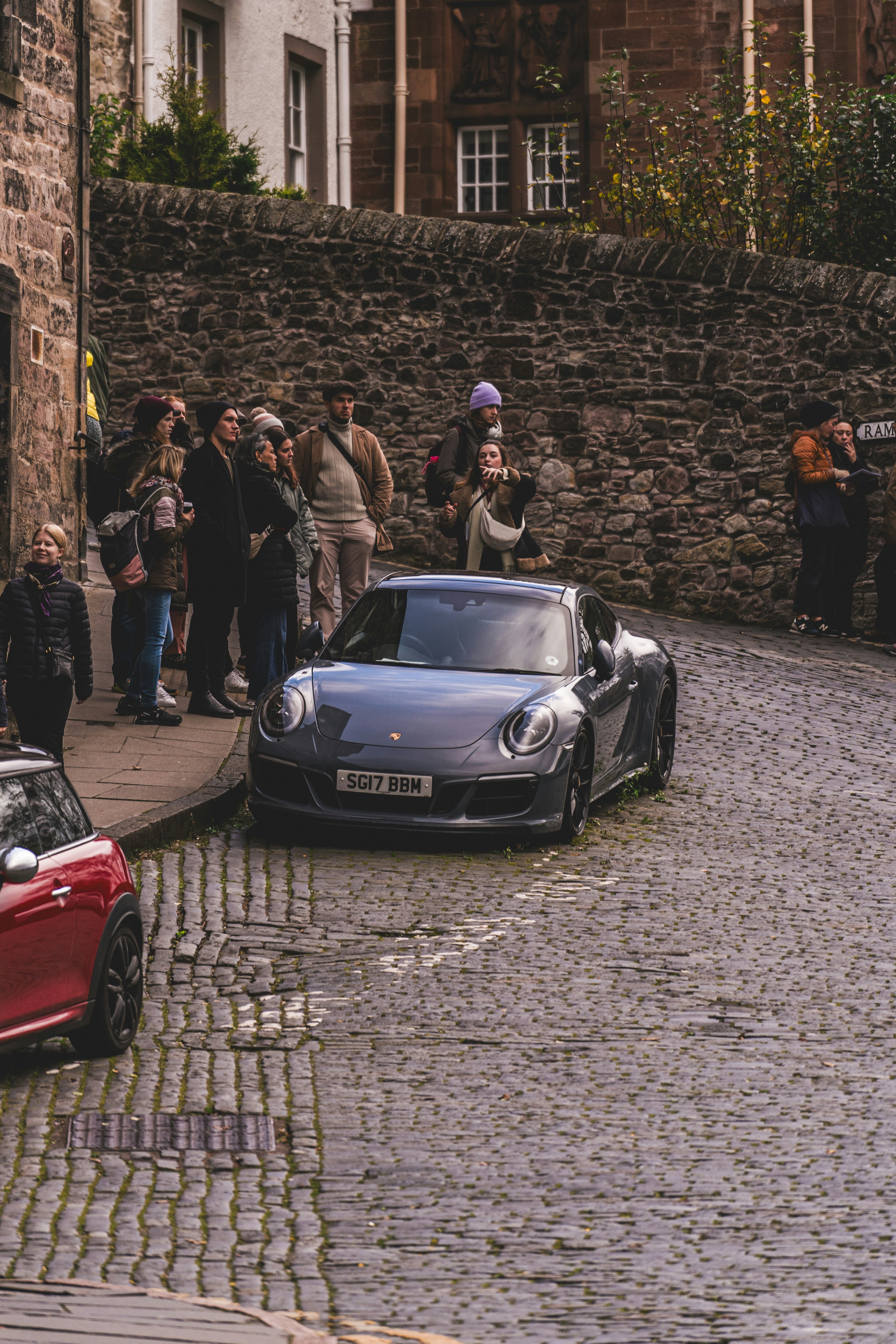 A group of people standing on the side of a road