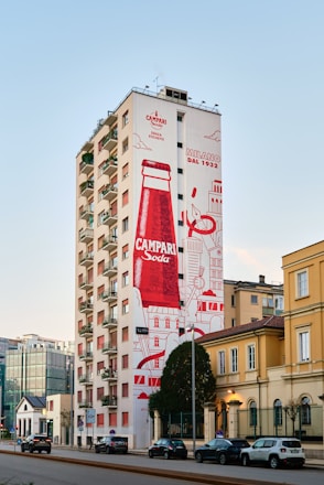 A tall building with a giant coca cola advertisement on it's side
