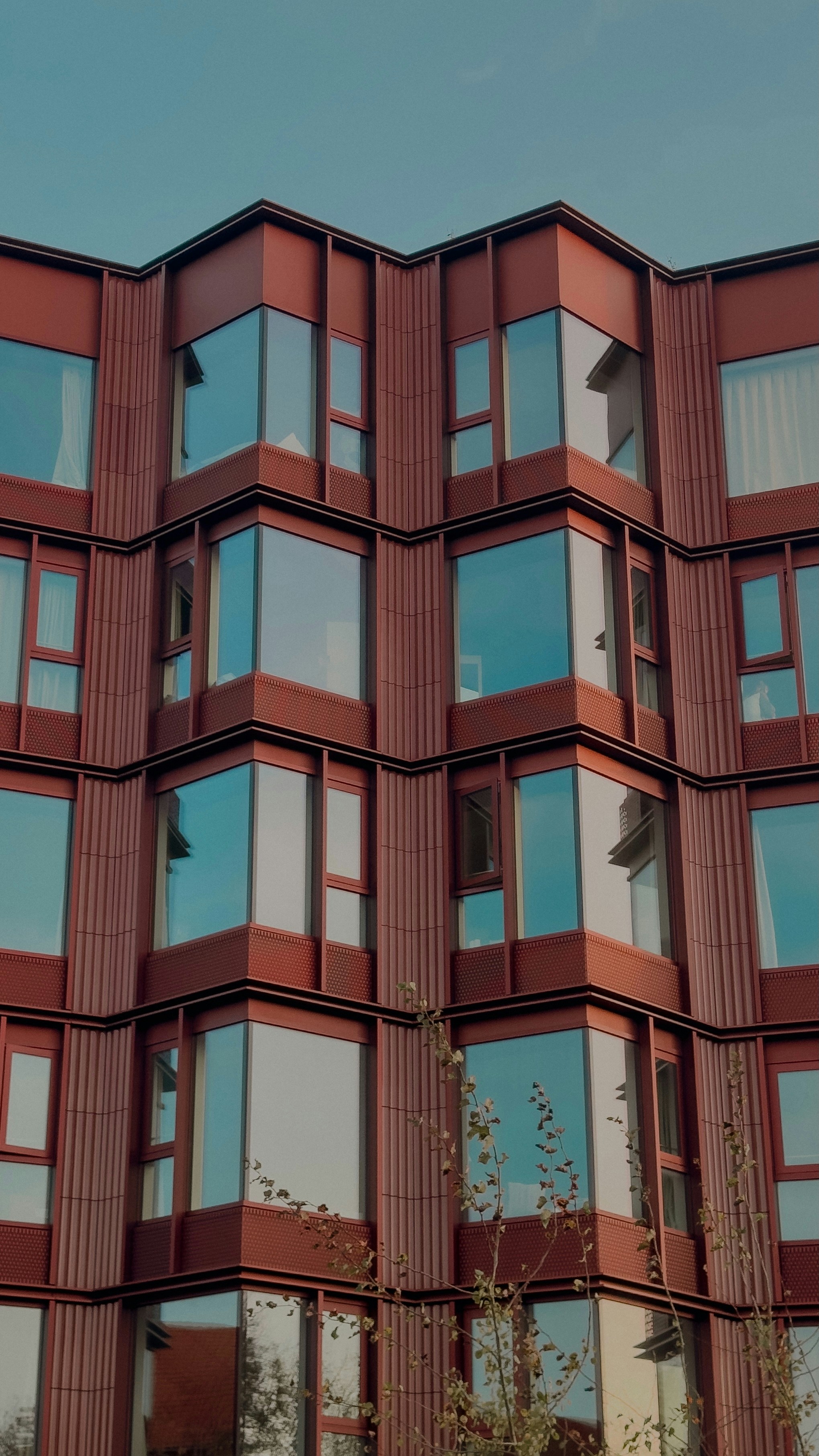 A tall red building with lots of windows