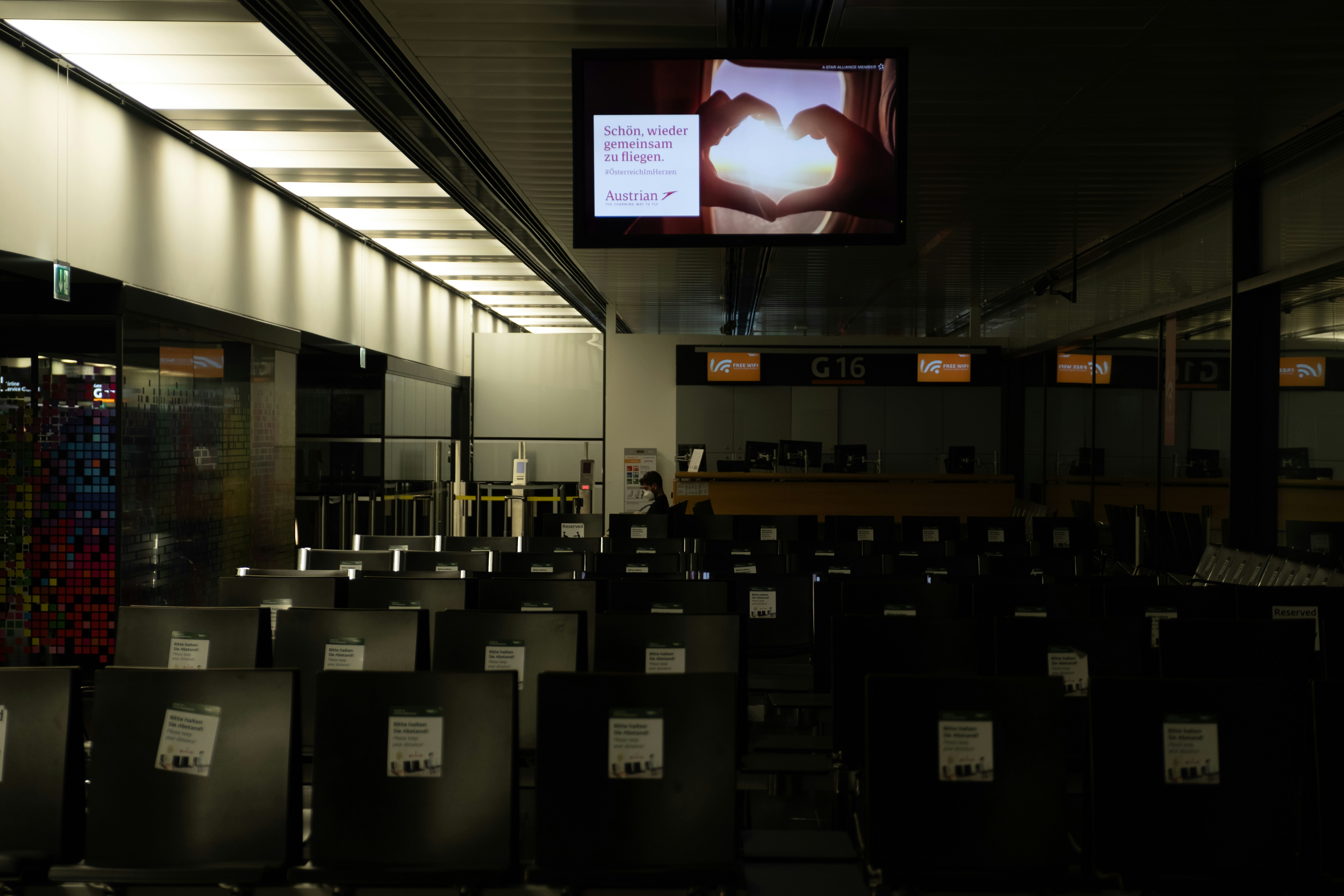 A large room with rows of chairs and a flat screen TV, 