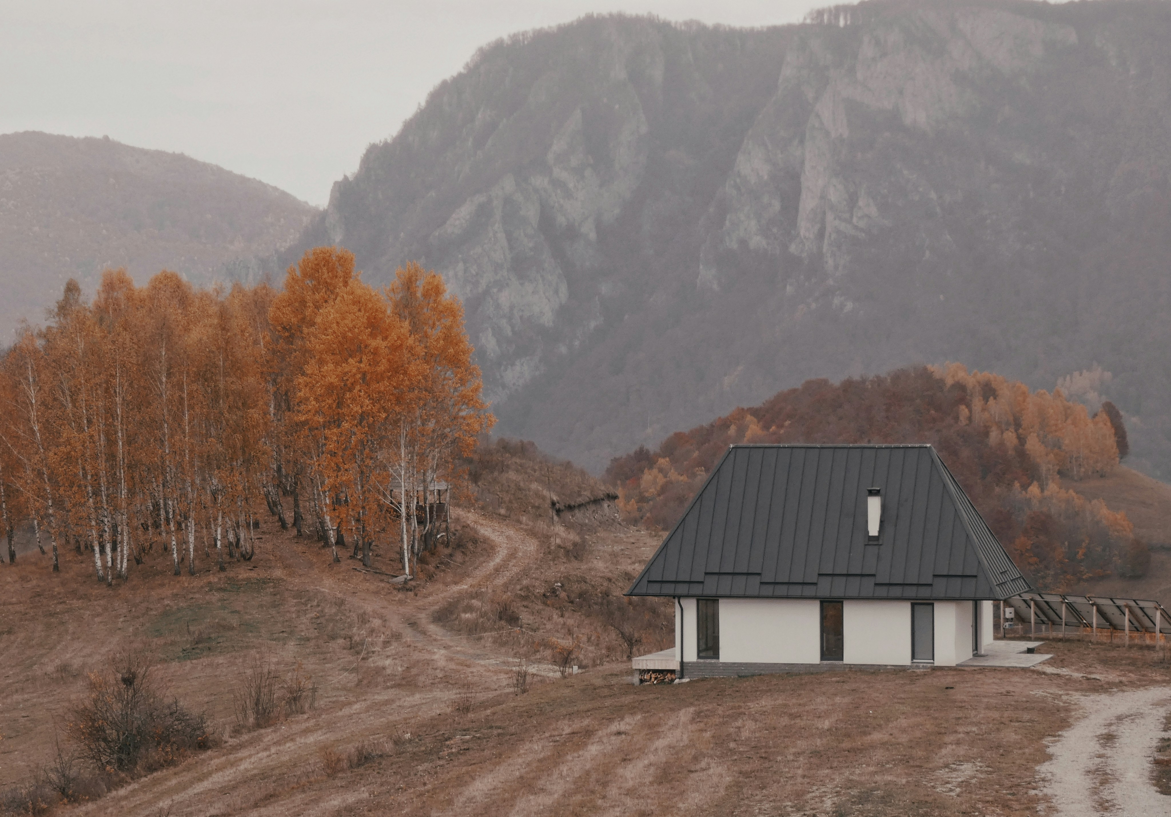 A house in the middle of a dirt road
