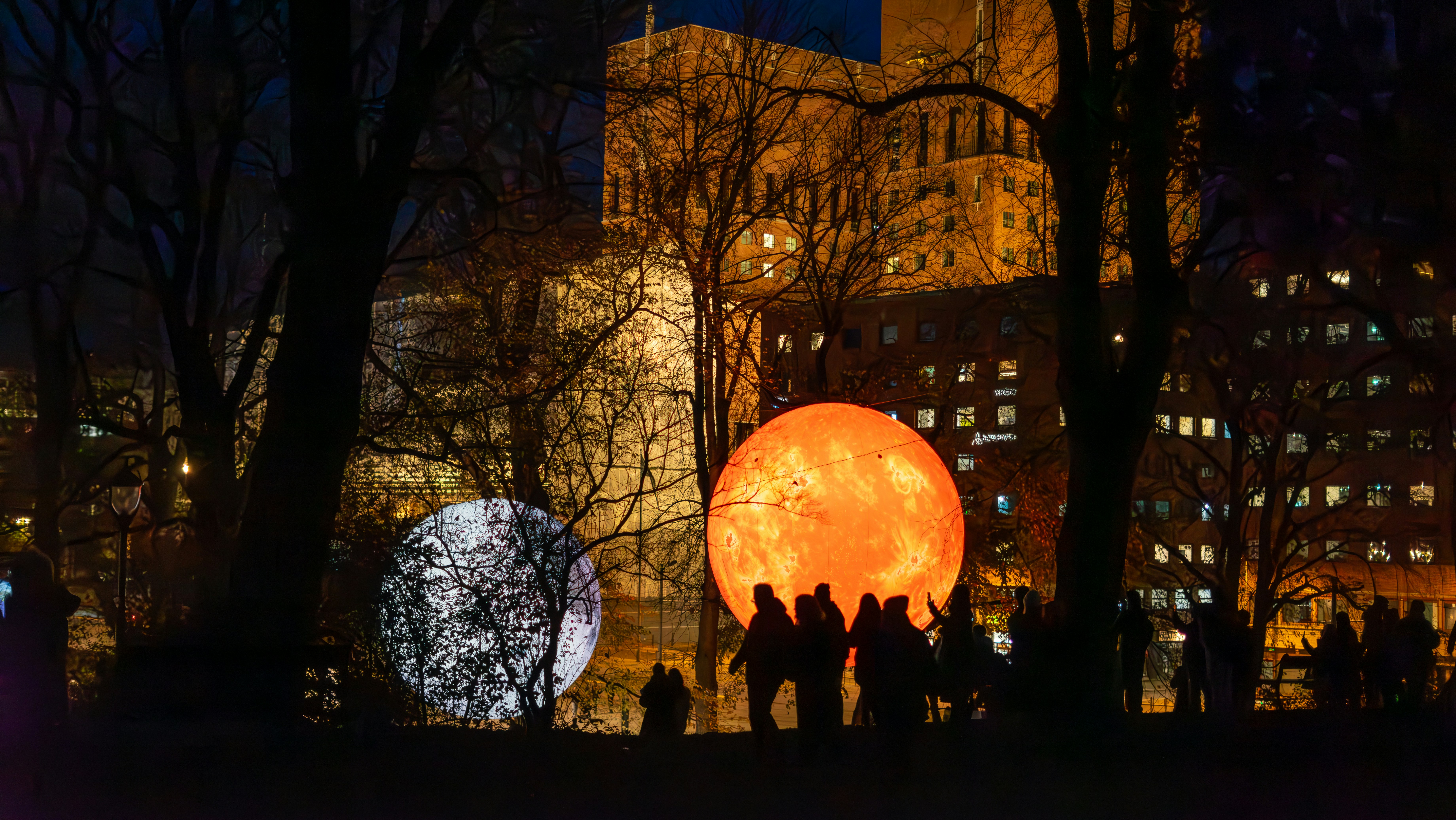 A group of people standing next to each other in a park
