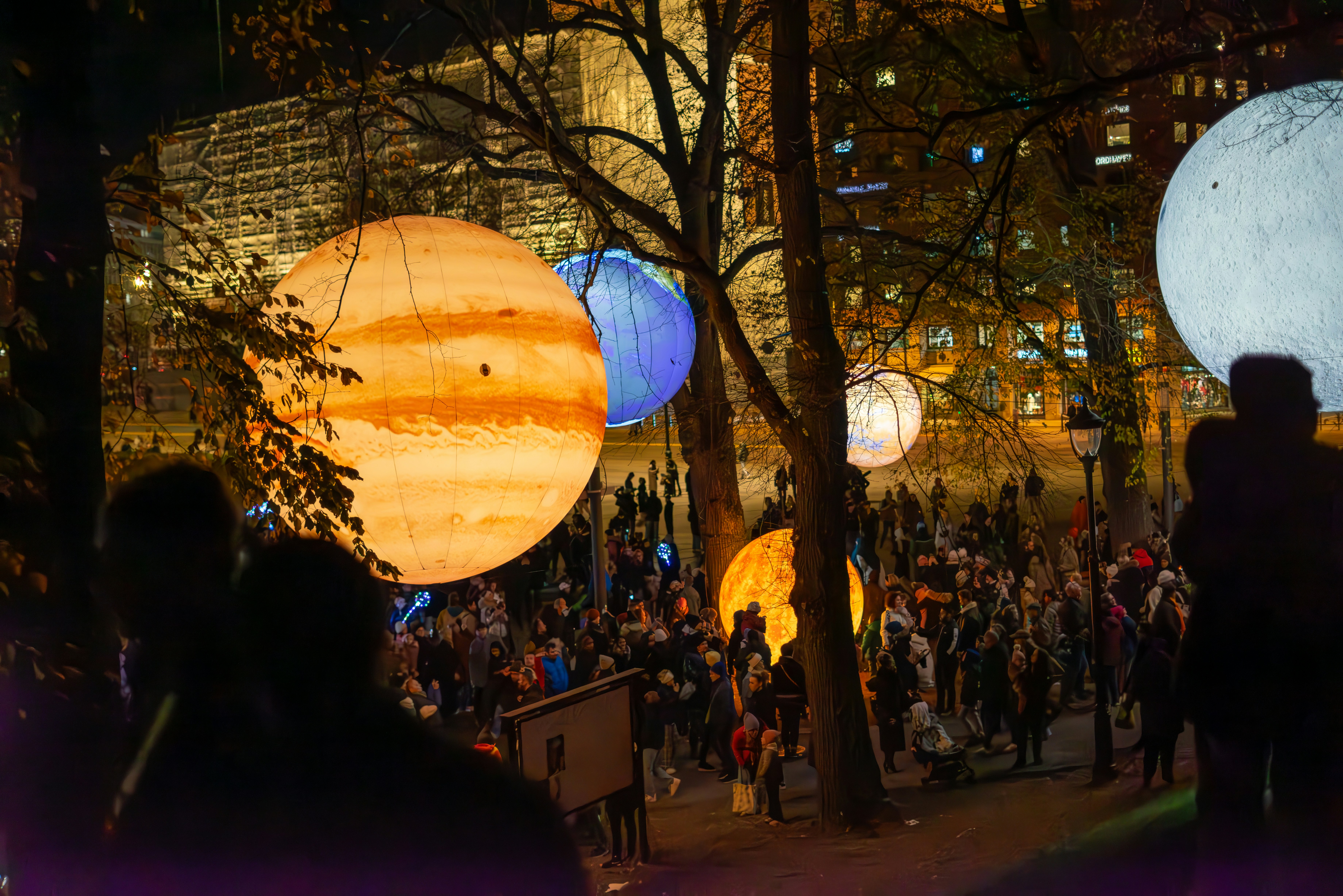 A group of people standing in front of a building at night