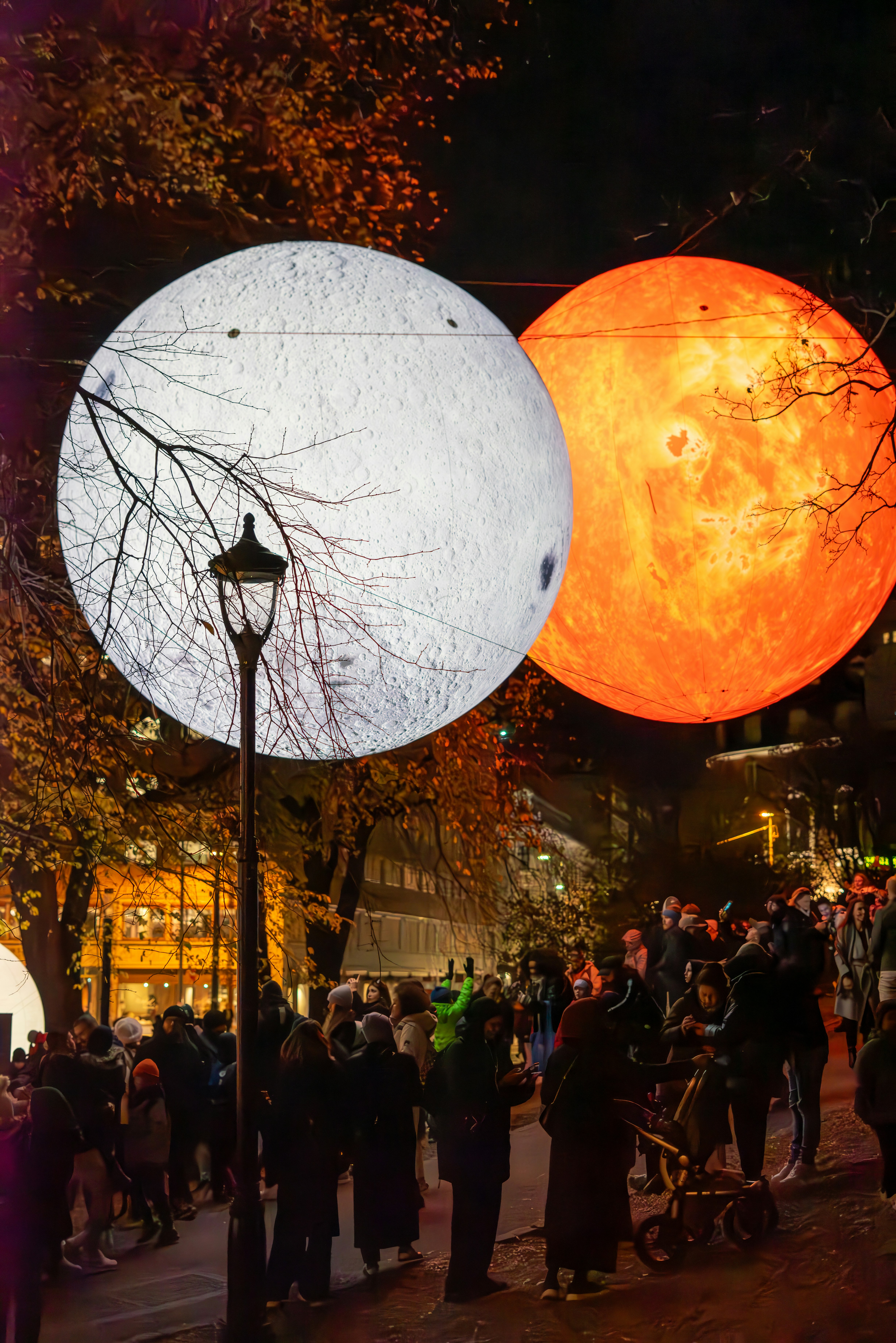 A group of people standing around a street light