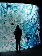 A person standing in front of a large wall