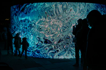 A group of people standing in front of a wall