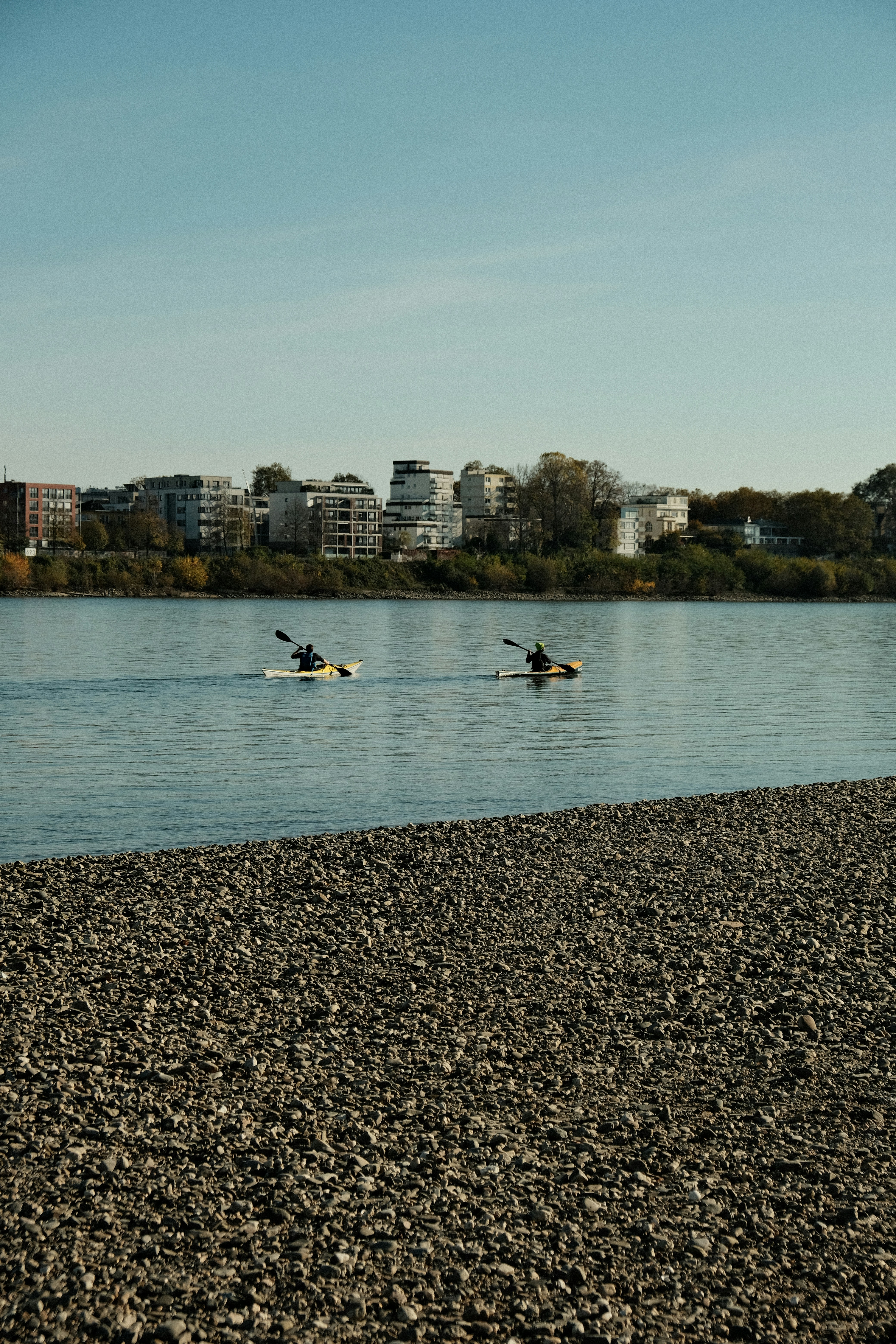Two people in kayaks paddling on the water
