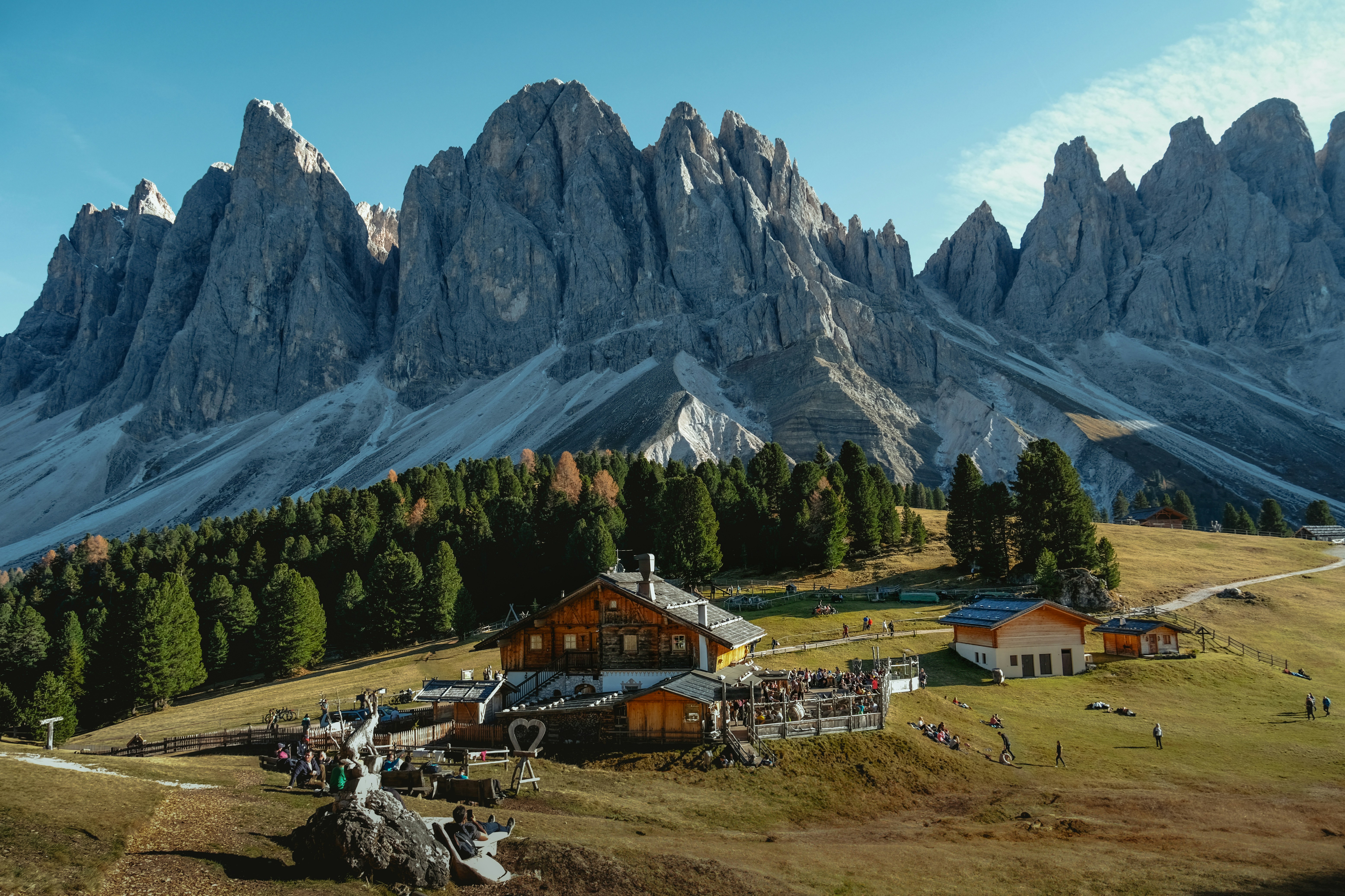 A painting of a mountain range with a small village in the foreground