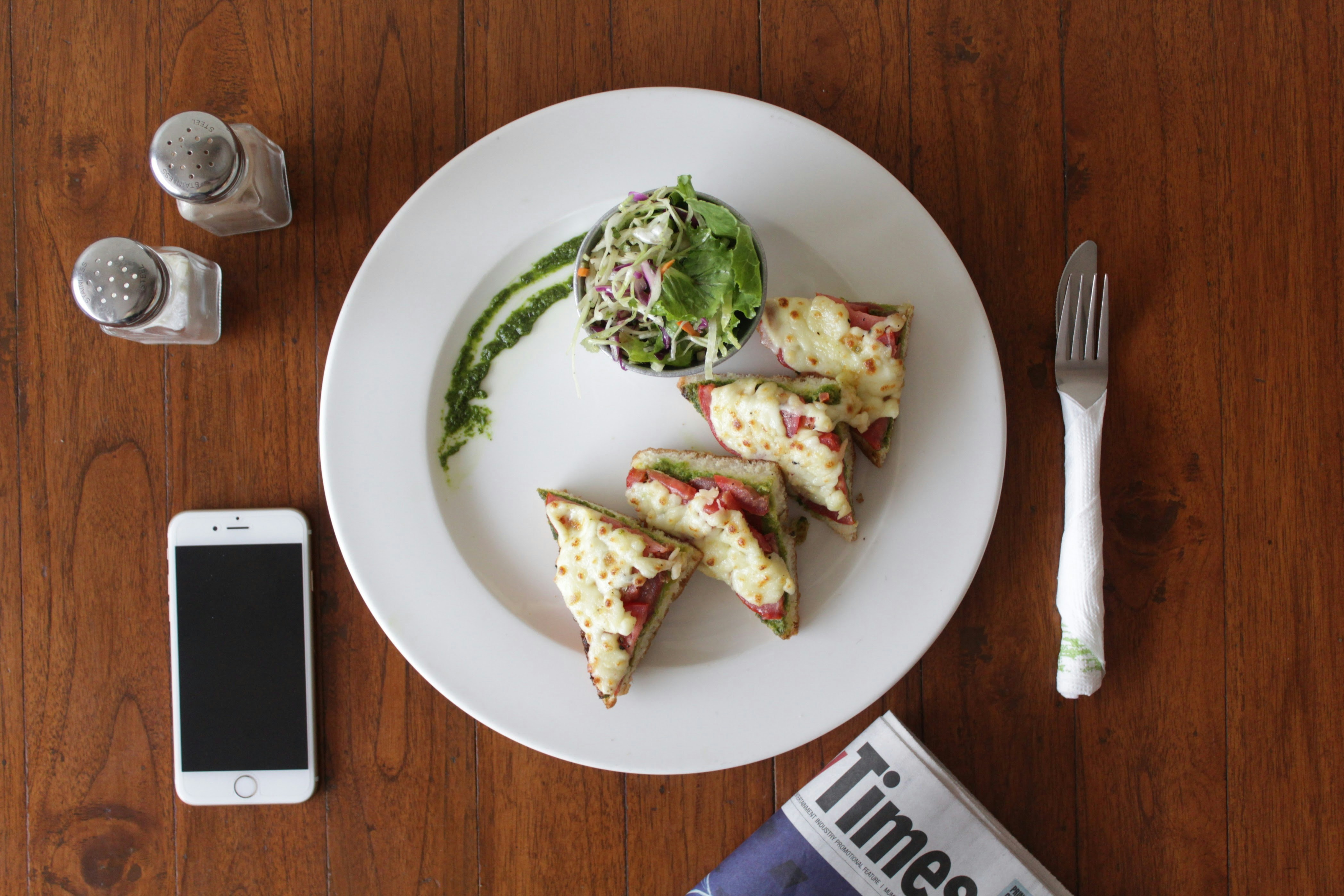 A white plate topped with three pieces of pizza