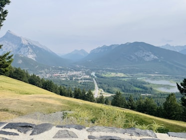 A view of a valley and mountains from the top of a hill