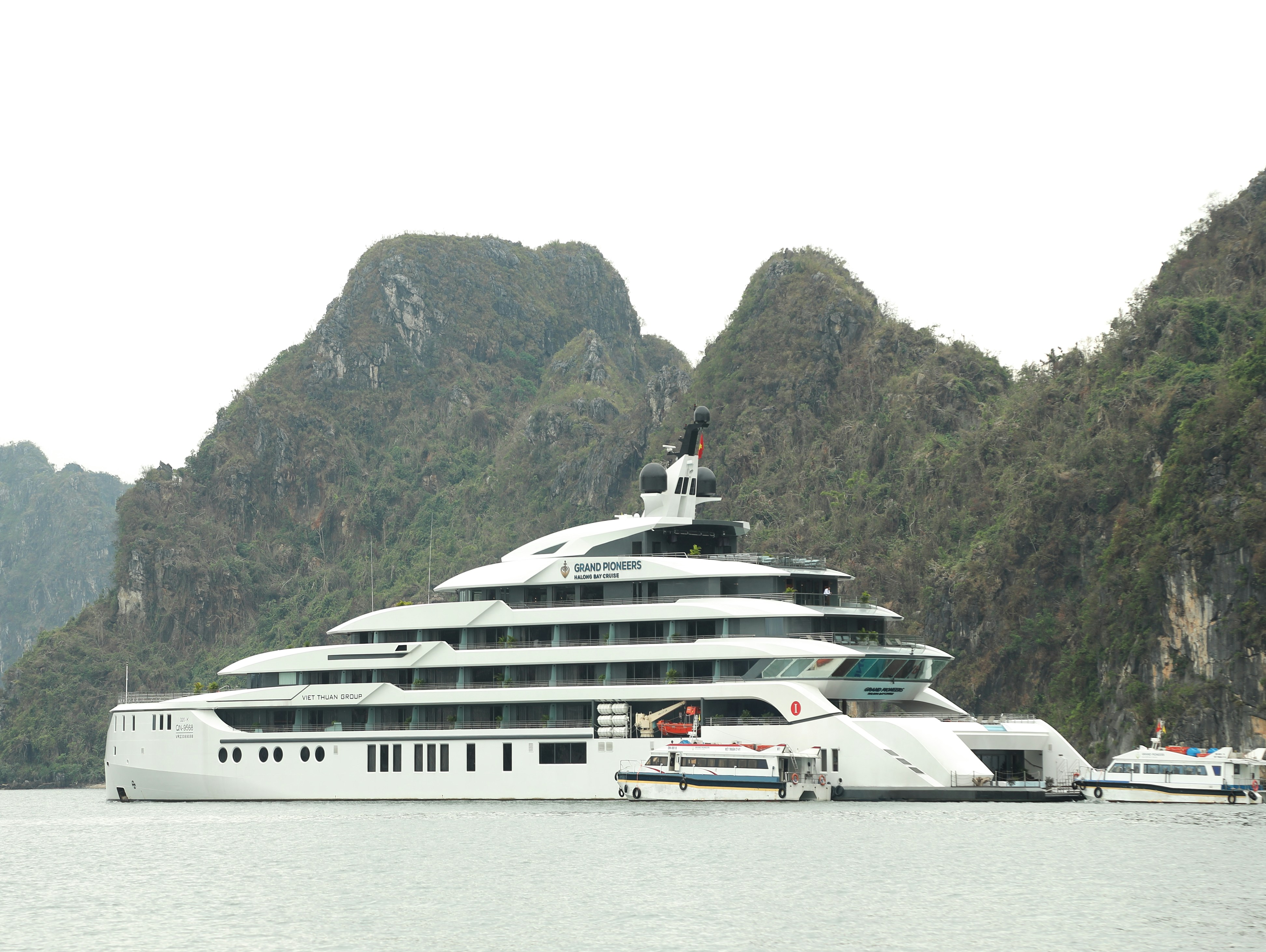 A large white boat floating on top of a body of water