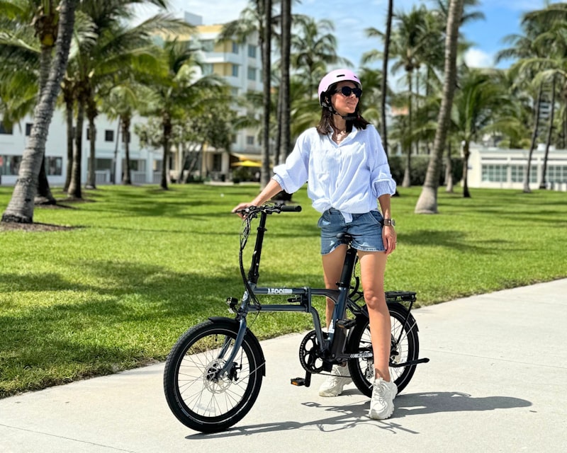 Woman with electric folding bike in city