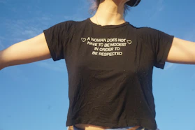 A woman in a black shirt is flying a kite