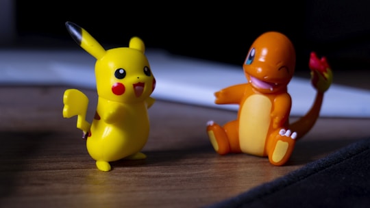 A couple of toy figurines sitting on top of a wooden table