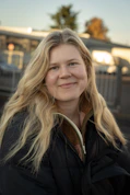 A woman standing in front of a train