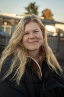 A woman standing in front of a train