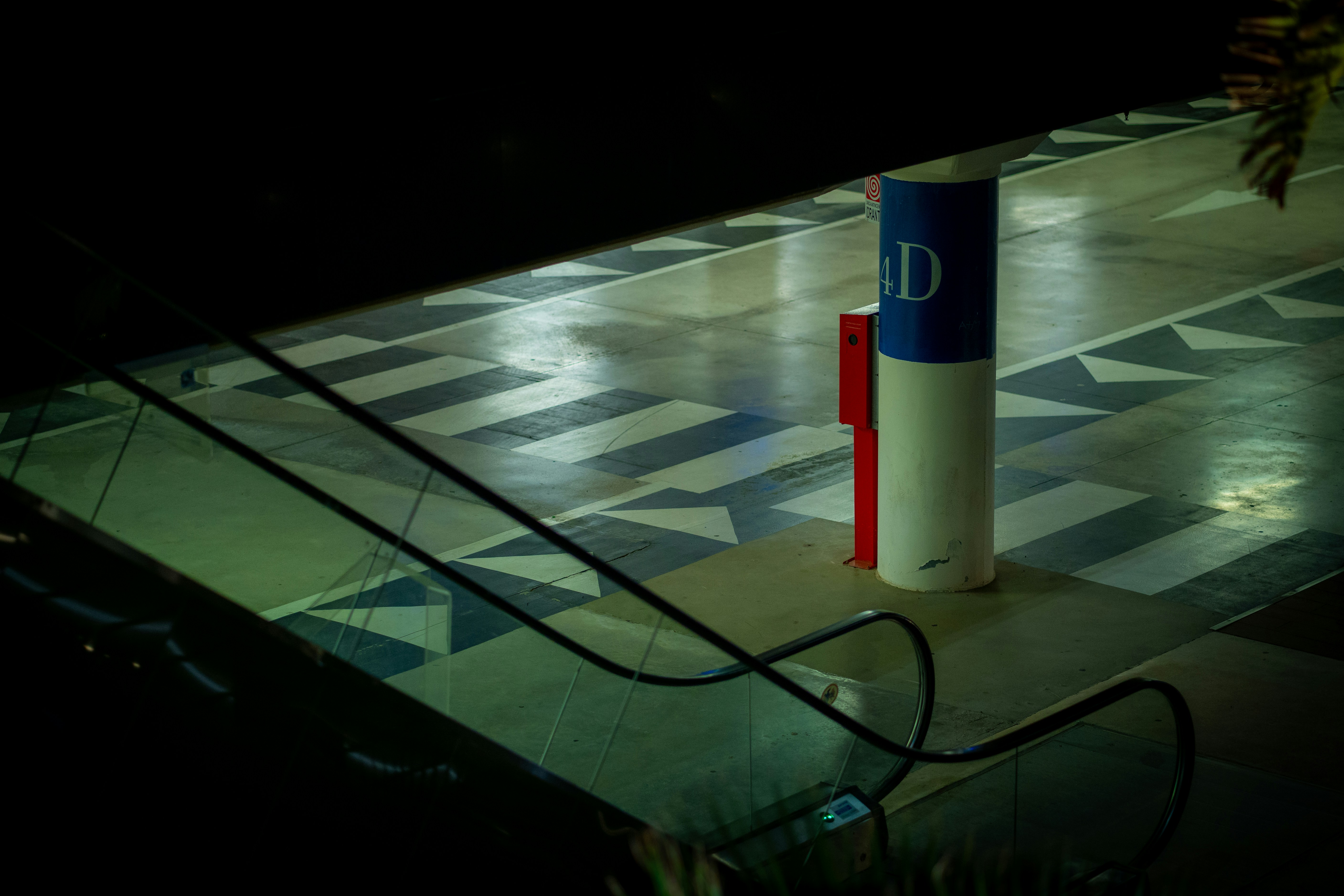 A parking meter sitting on top of a checkered floor