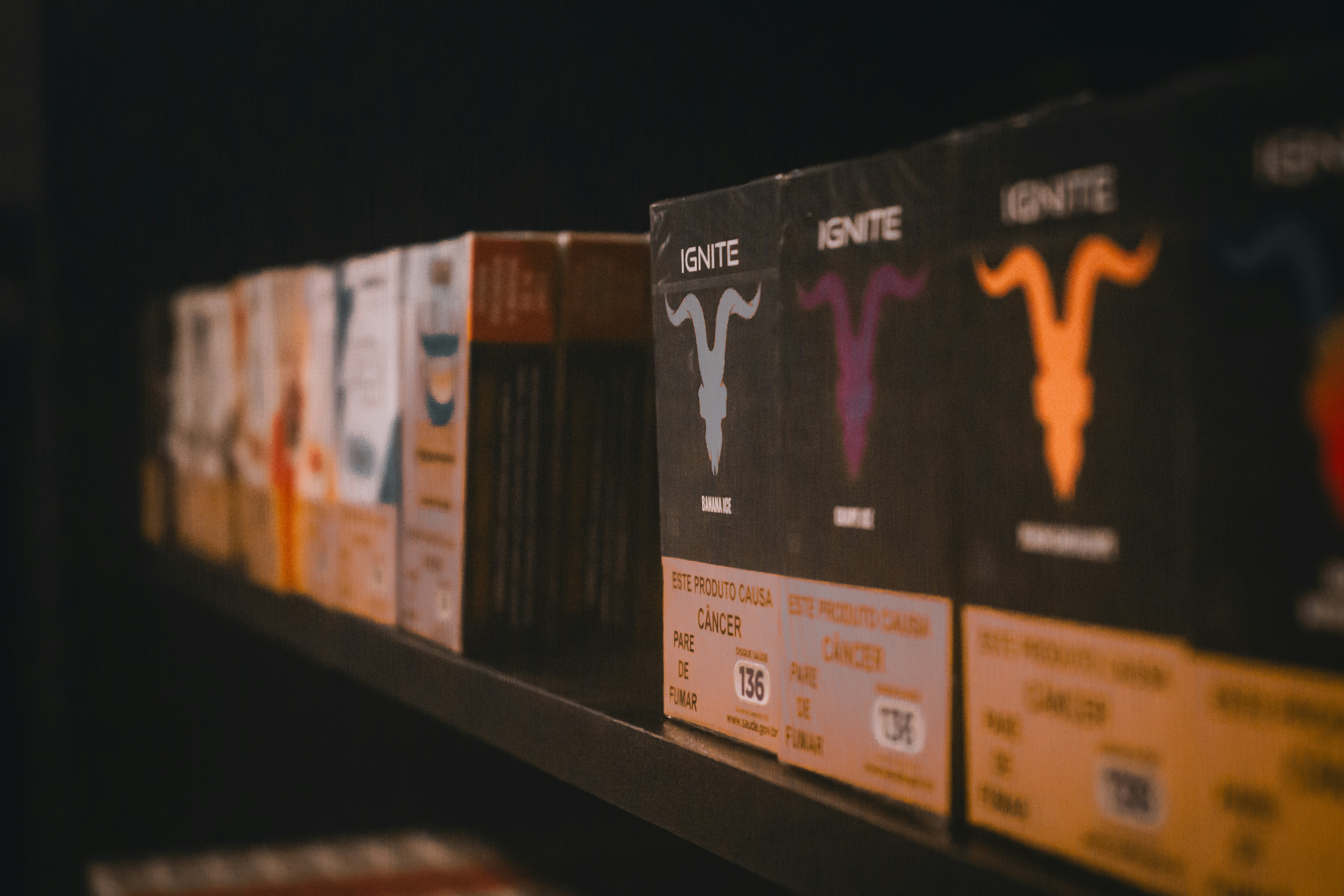 A row of cassettes sitting on top of a shelf