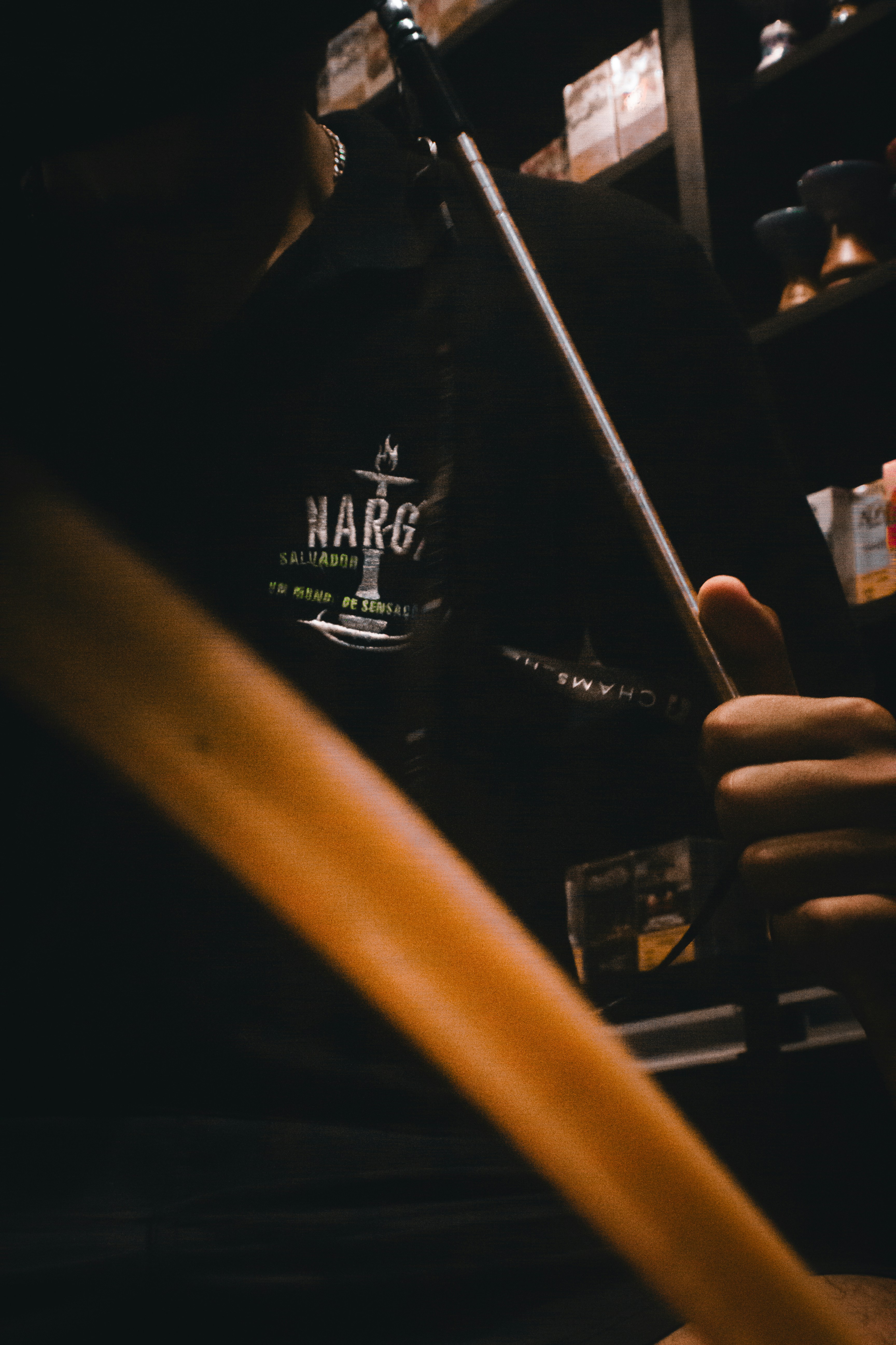 A person holding a knife in a dark room