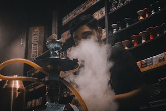 A man smoking a pipe in a coffee shop