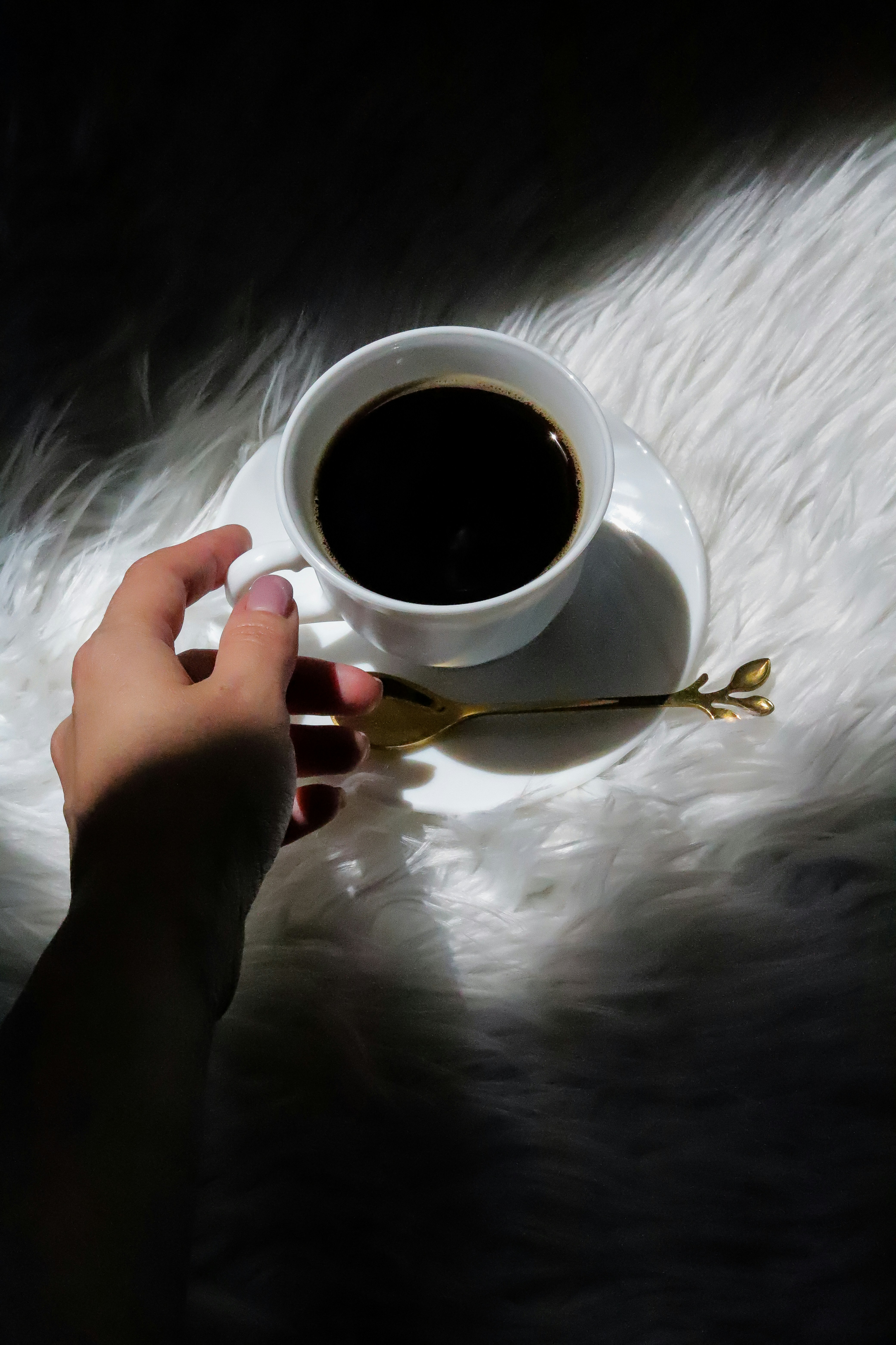 A person is holding a cup of coffee