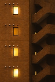 A tall brick building with a clock on the side of it