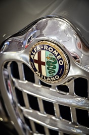 A close up of a alfa logo on a car