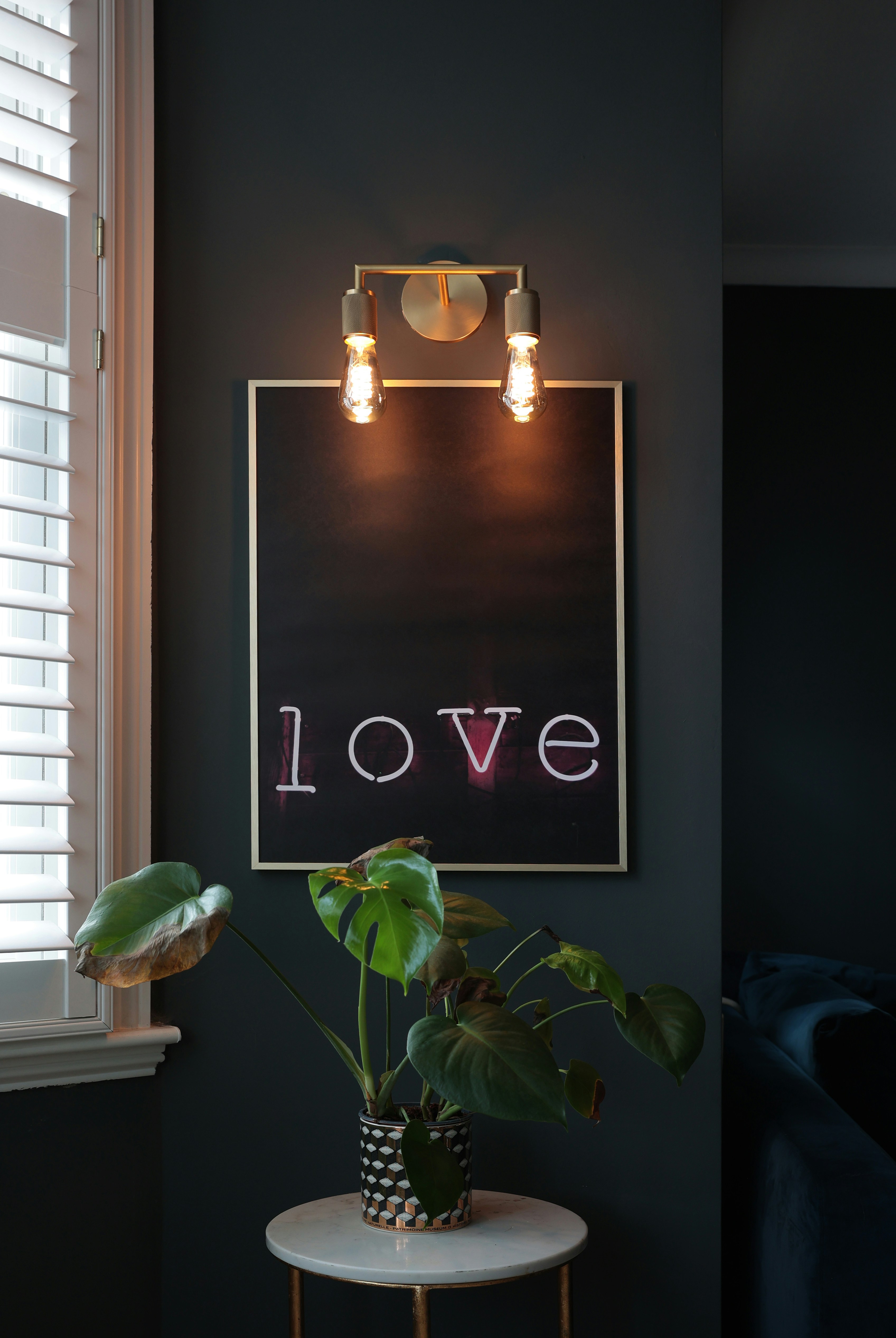 A picture of a love sign hanging on a wall