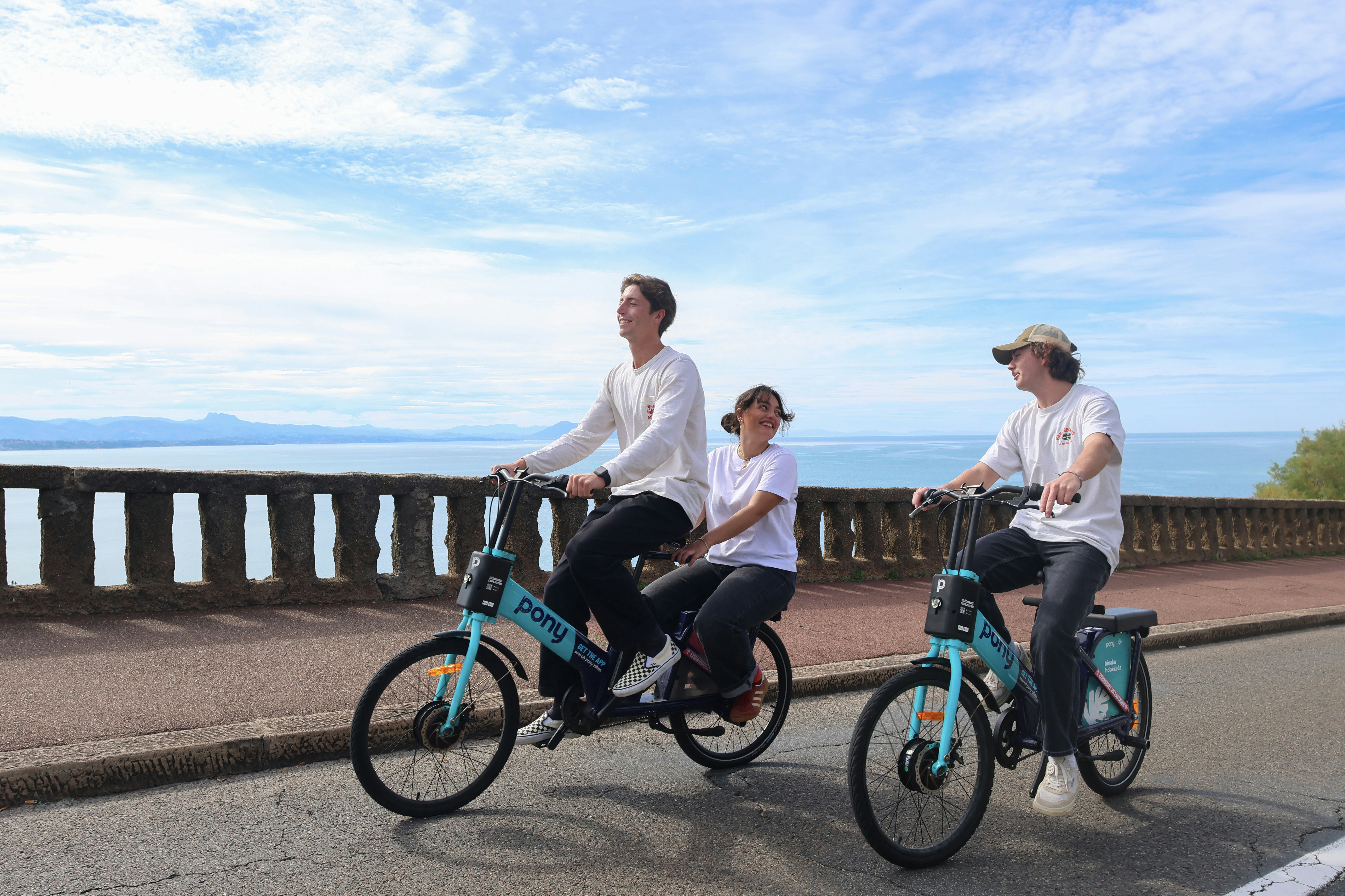 a group of people riding bicycles down a street