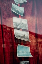 A red curtain with pictures hanging on it