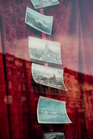 A red curtain with pictures hanging on it