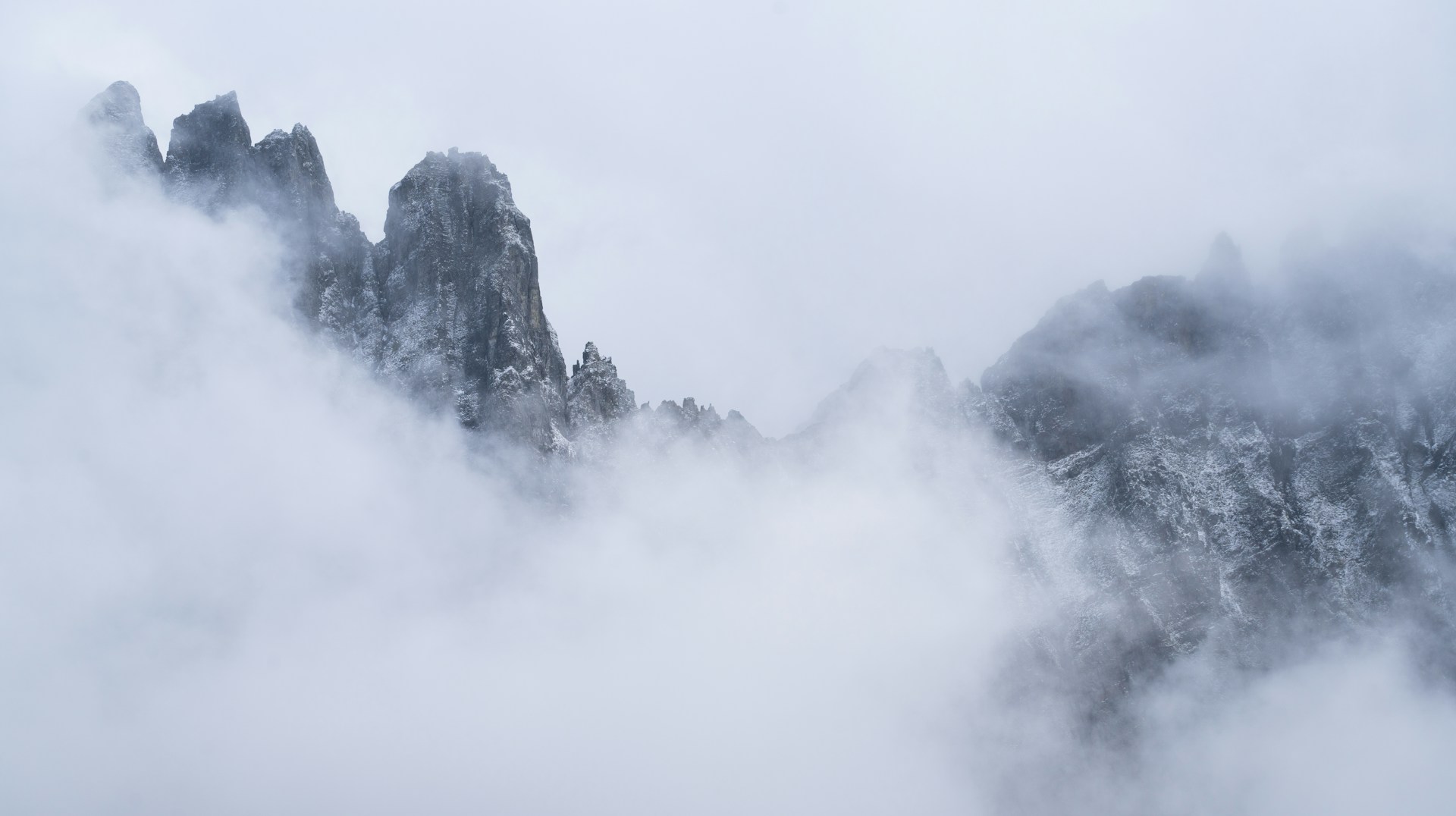 A mountain covered in fog and clouds in the distance