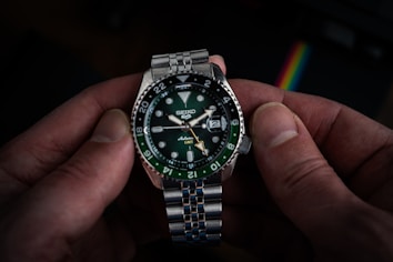 A person holding a watch in their hand