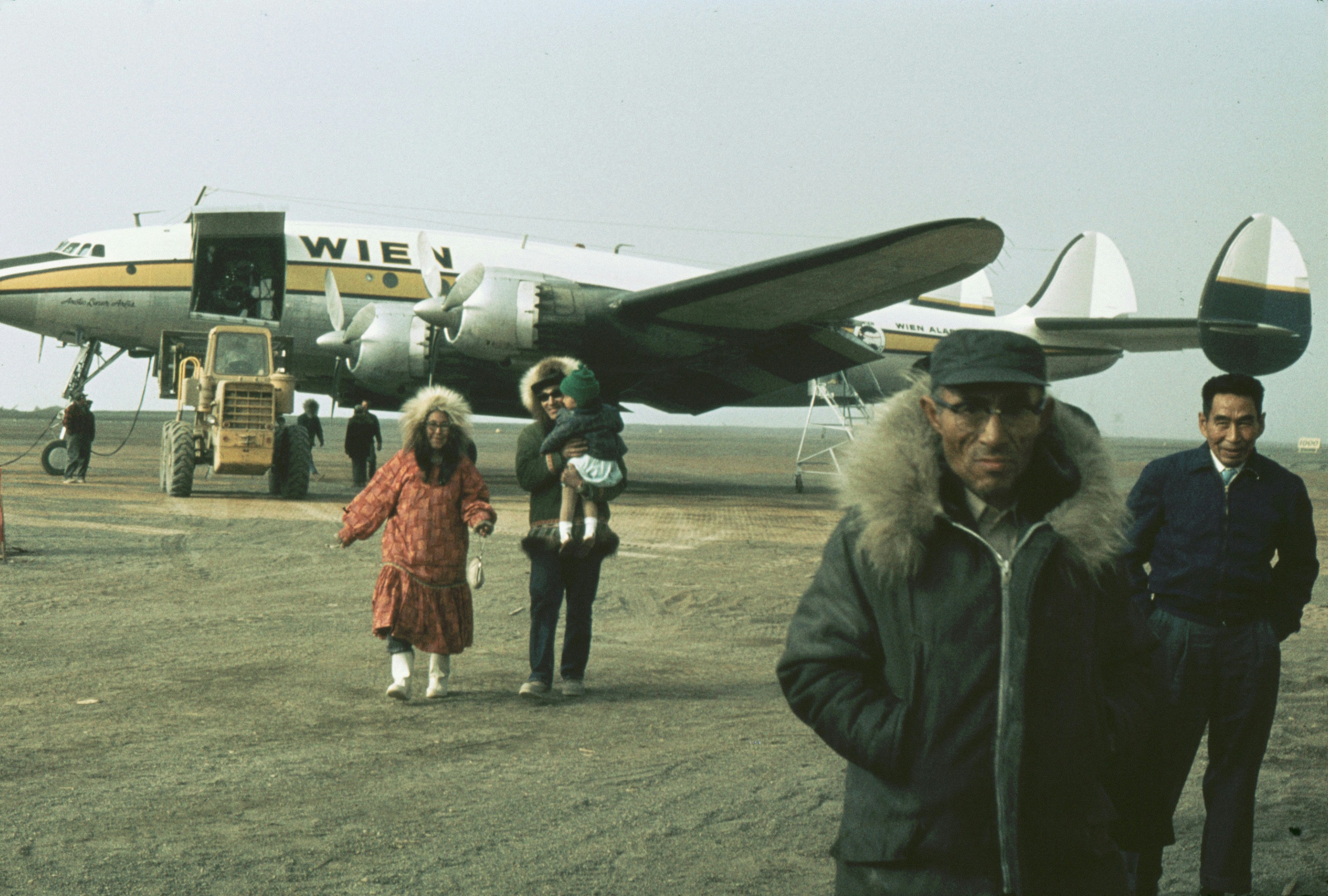 Alaska, United States Eskimo people at airport; Point Barrow, Alaska. No roads connect Point Barrow with the rest of the state. Planes are the primary access to the area.