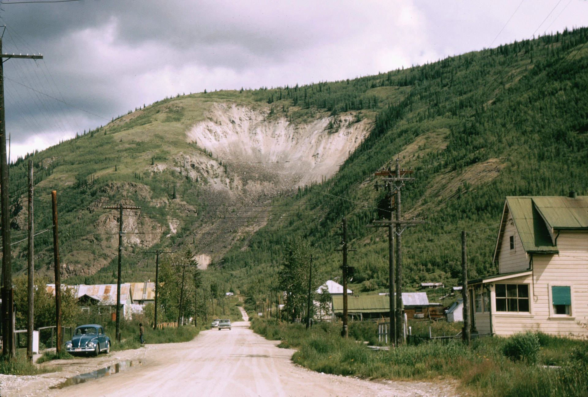 A small town nestled at the base of a mountain.