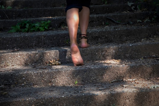 A woman walking up some steps with her shoes on
