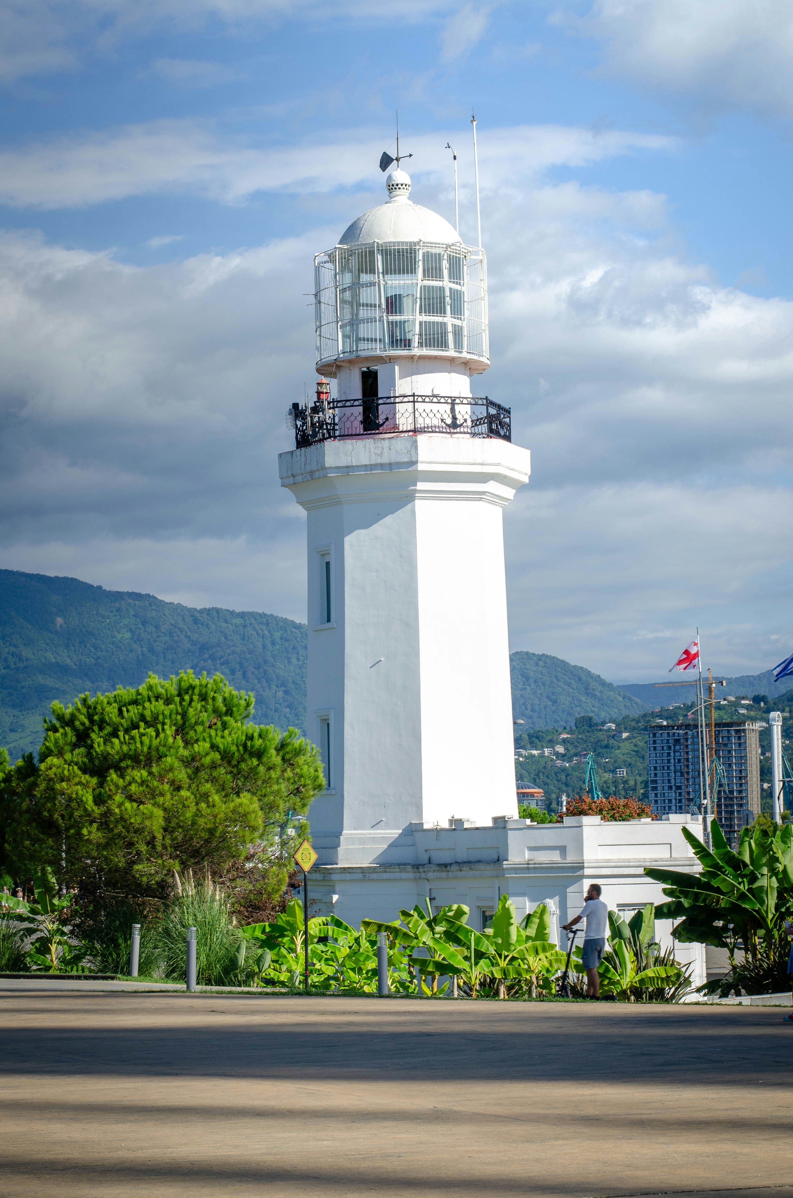 A white lighthouse with a sky background