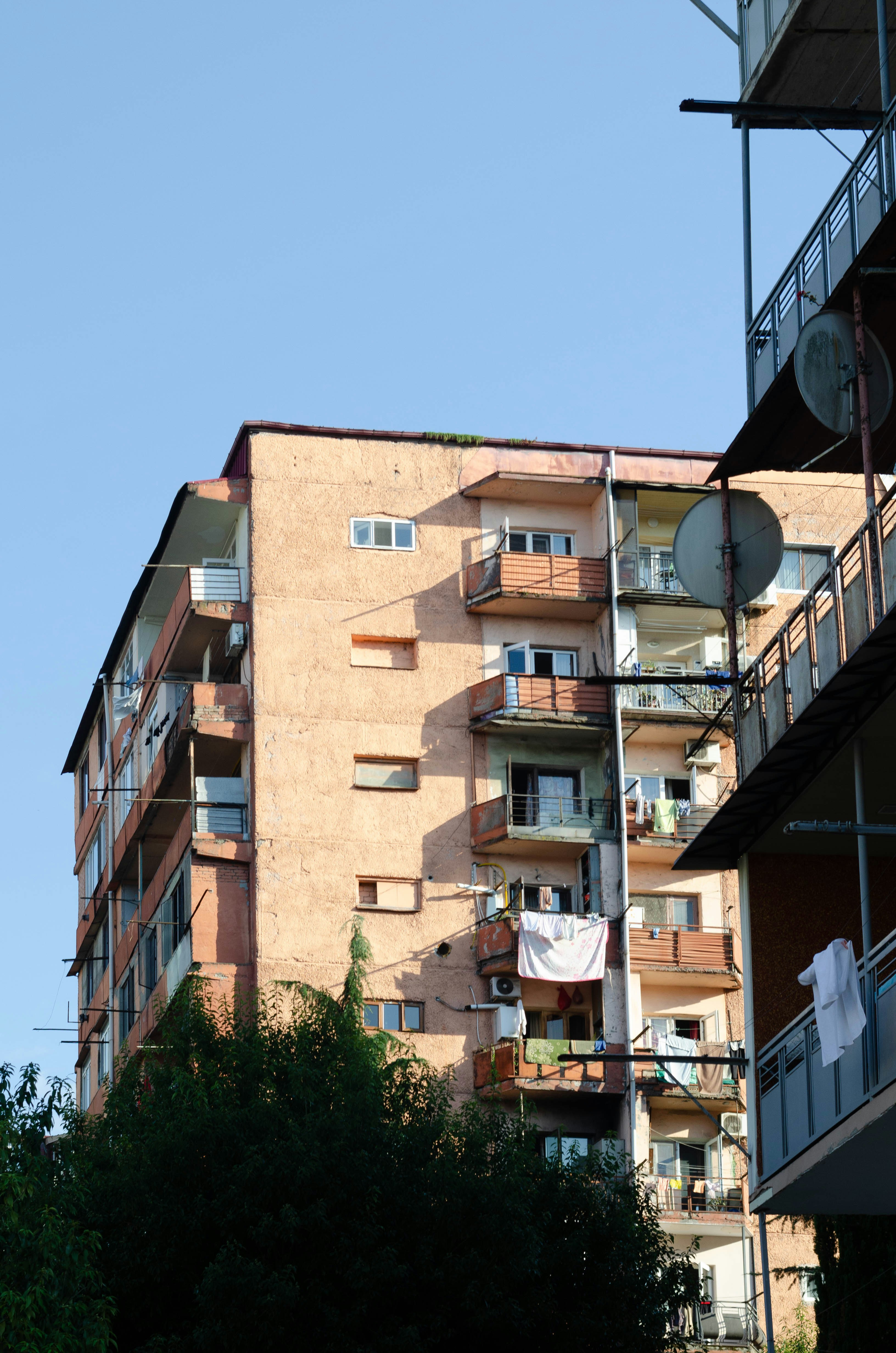 A tall building with balconies and balconies on the balconies