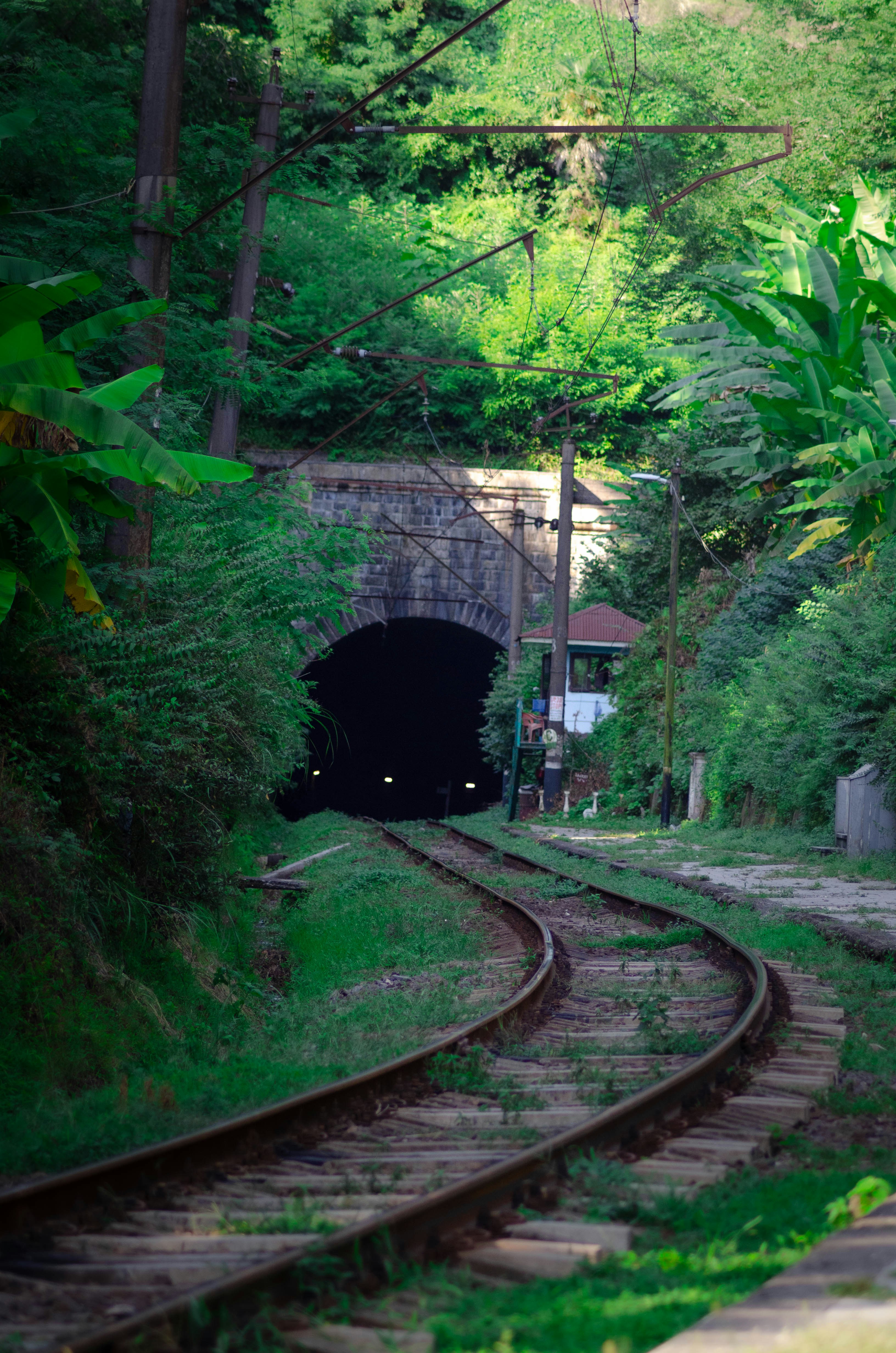 A train track with a tunnel in the middle of it